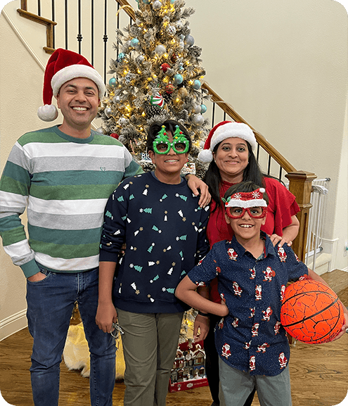 Dr. Mansi Talsania with her family wearing Santa hats and Christmas glasses