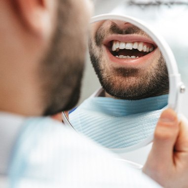 Patient looking at smile in reflection