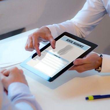 Patient looking at dental insurance form on tablet