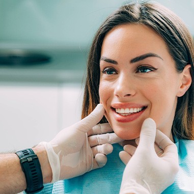 Dentist looking at smiling patient's teeth