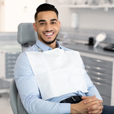 Patient smiling while sitting in treatment chair