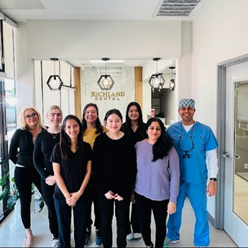 Dental team members in reception area smiling
