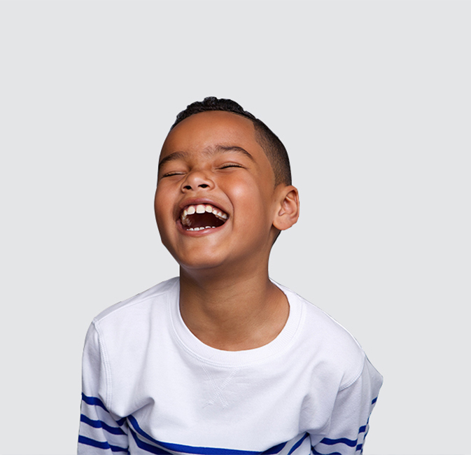 Young boy laughing after childrens dentistry in Richardson