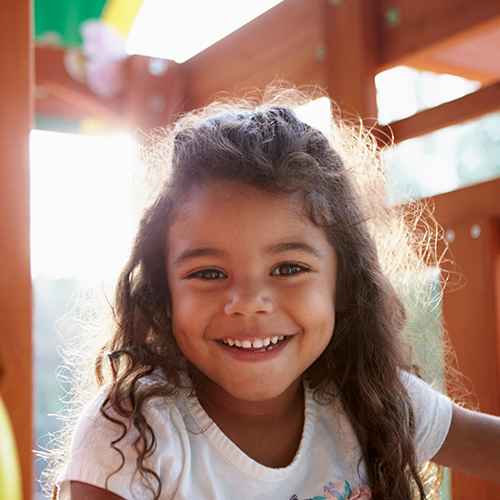Little girl playing in a fort