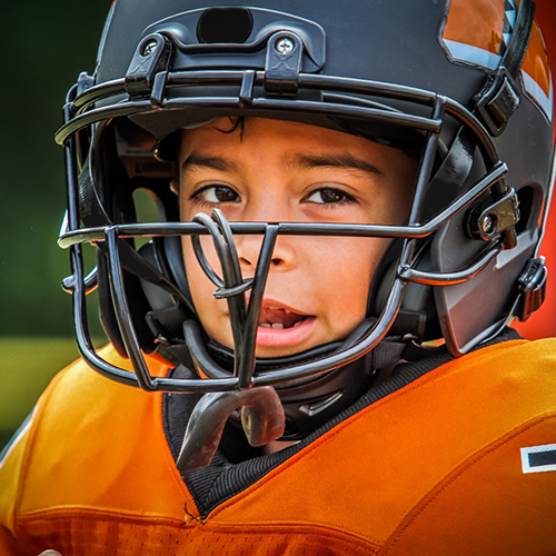 Close up of little boy in a football uniform