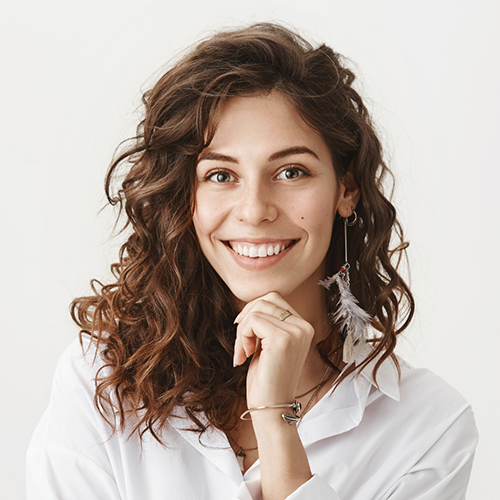 Close up of woman in button up shirt smiling
