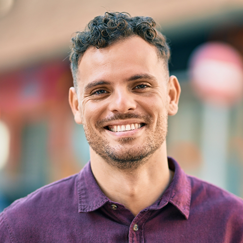 Man in purple shirt smiling