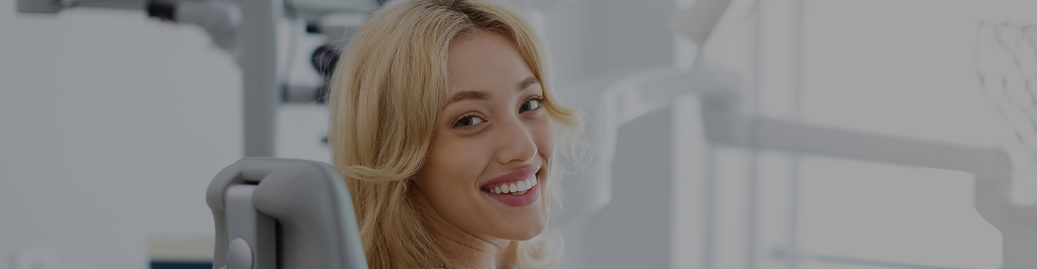 Woman in dental chair smiling