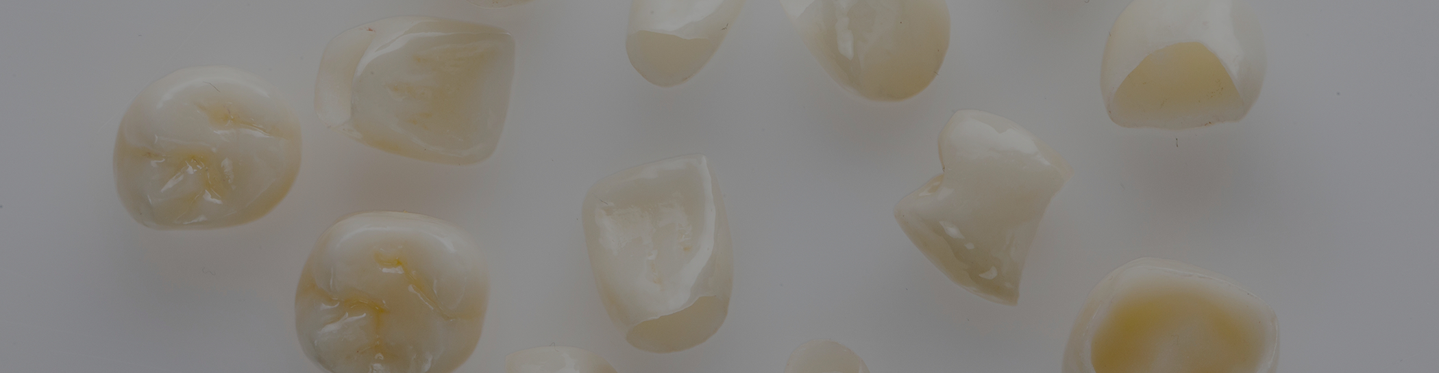 Multiple dental crowns in Richardson on white surface