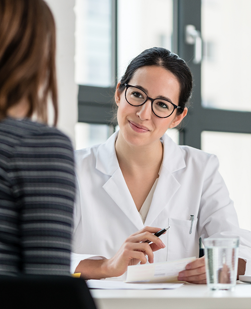Woman with glasses smiling at patient