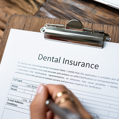 Dental insurance form on clipboard