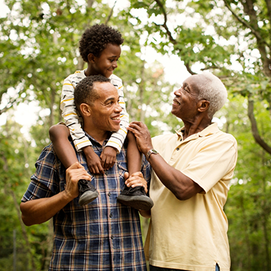 Two men with one giving a child a piggyback ride