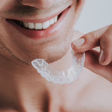 Man about to put in clear aligner