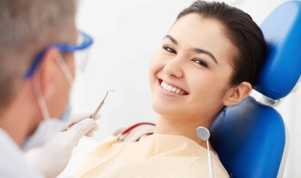 Young woman grinning in dental chair