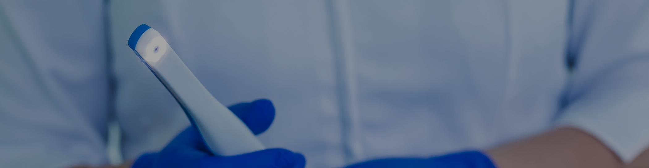 Gloved hand holding intraoral scanner