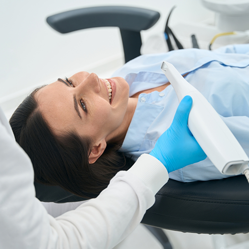 Female patient about to have teeth scanned with intraoral camera