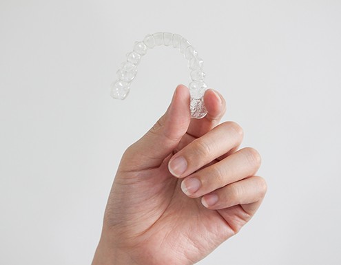 Patient holding clear aligner