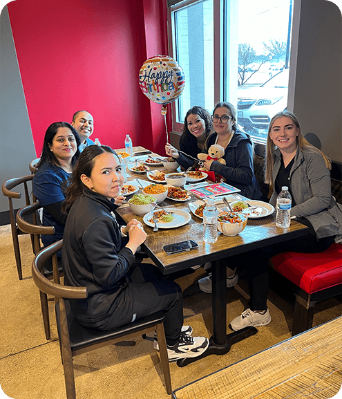 Dental team at tables in restaurant enjoying a meal