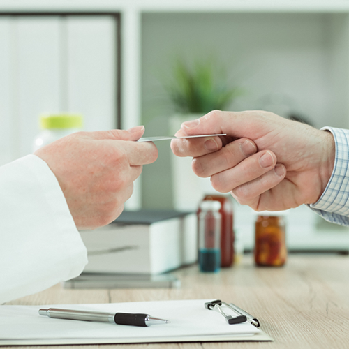 Taking credit card from patient over desk