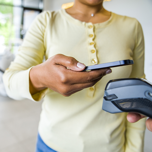 Woman in yellow shirt holding phone