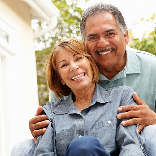 Smiling man and woman in button up shirts