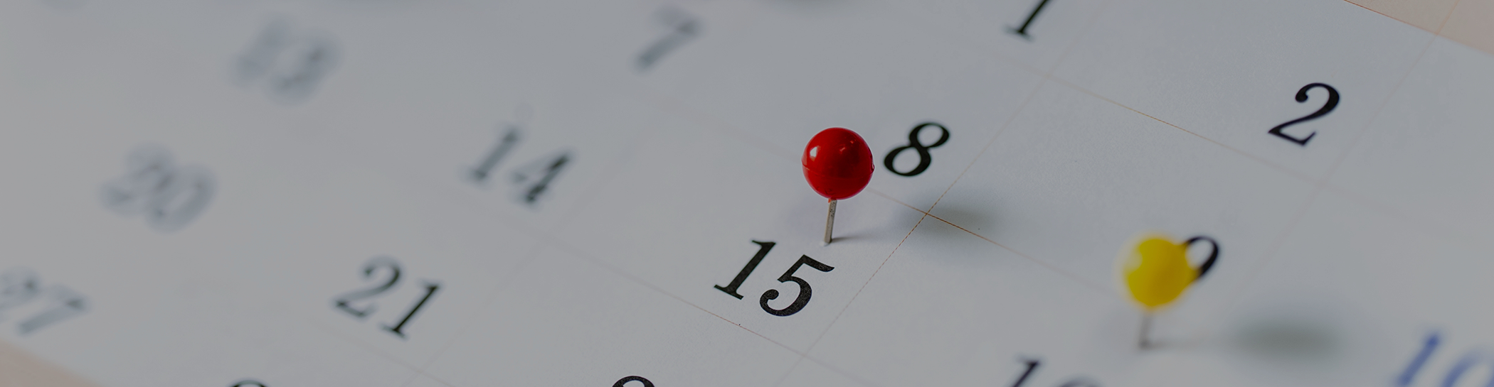 Calendar with thumbtack to mark date of dental appointment