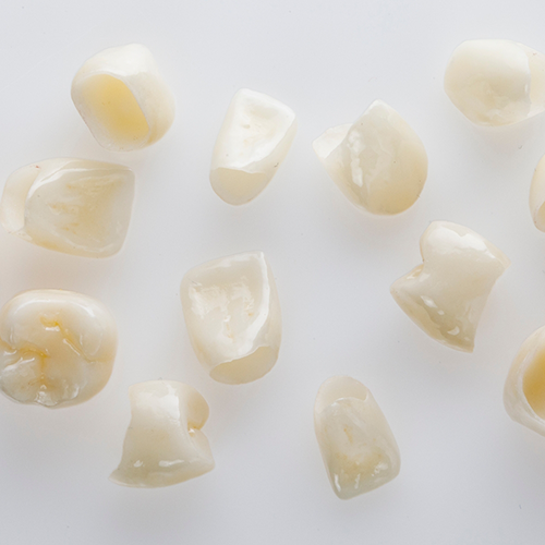 Multiple dental crowns on white surface