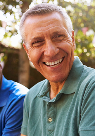 Man in green shirt smiling