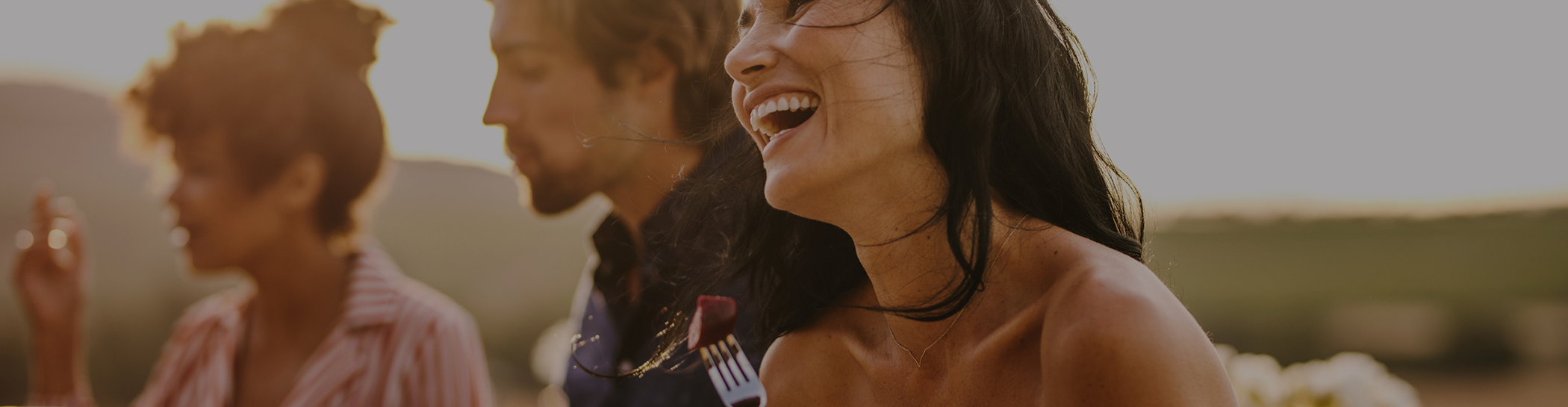 Woman with other people smiling outside