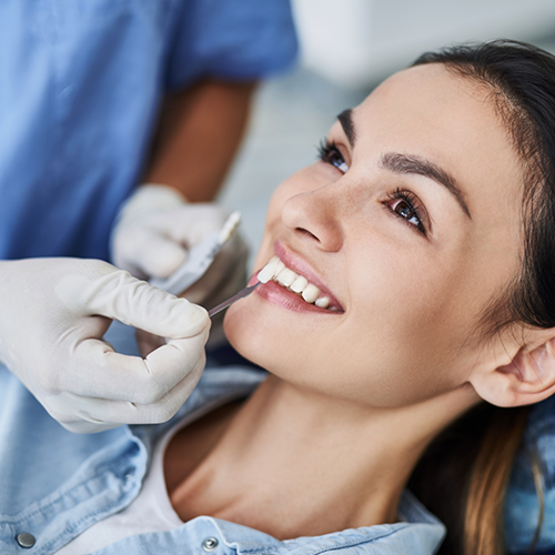 Female patient having teeth shade matched for veneers