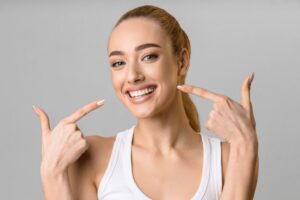 Woman smiling after getting a cosmetic dental treatment