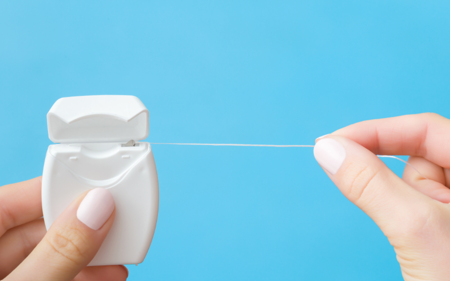 Hands holding dental floss